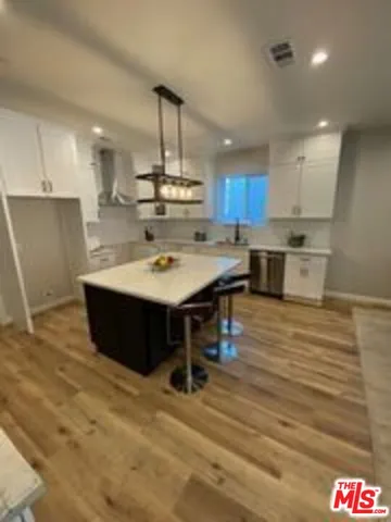 a large kitchen with a table and chairs in it