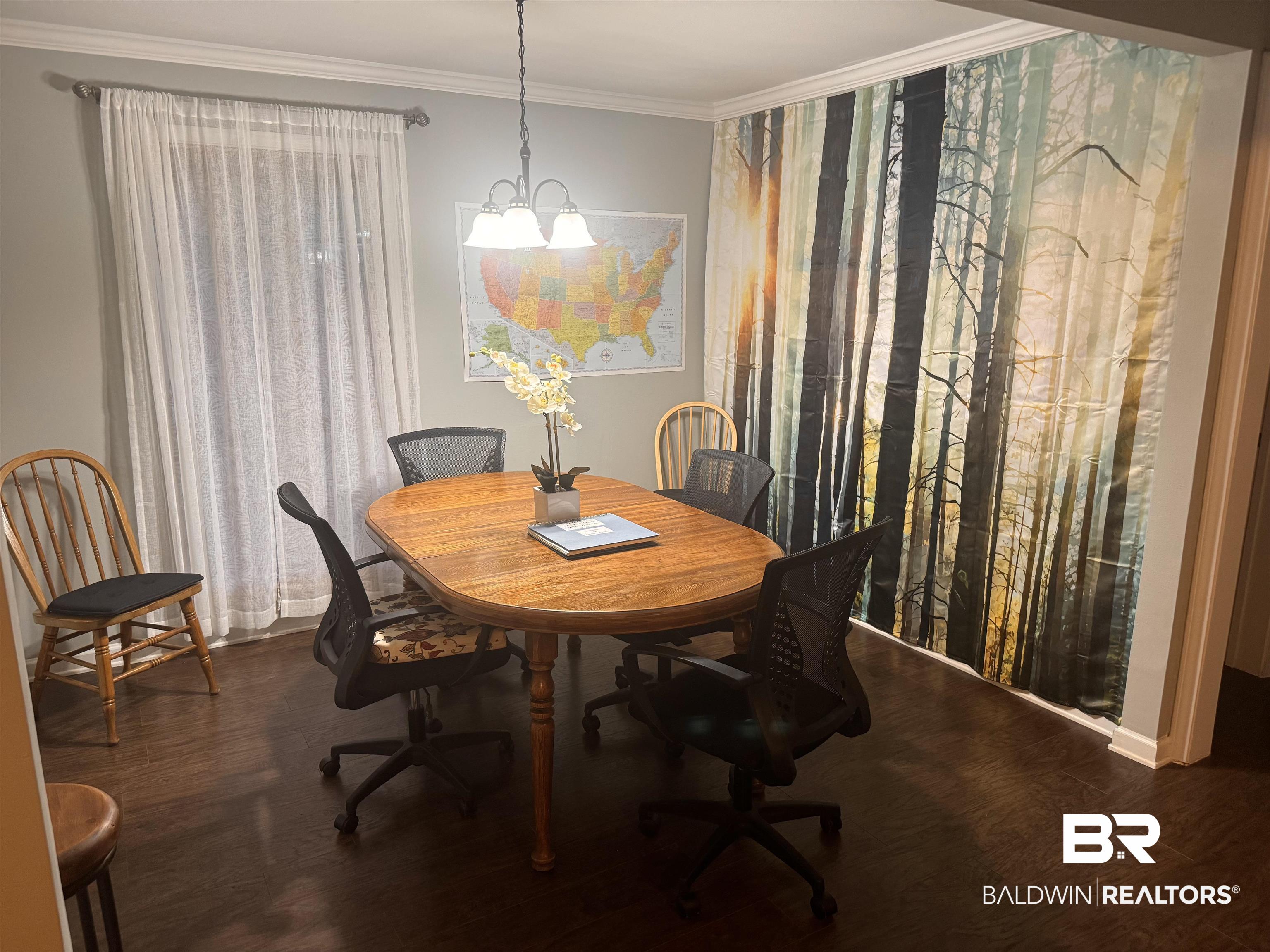 1302 Oak Street Daphne, AL 36526 - Photo 25 of 34 Dining room featuring hanging lights, dark wood-type flooring, and crown molding