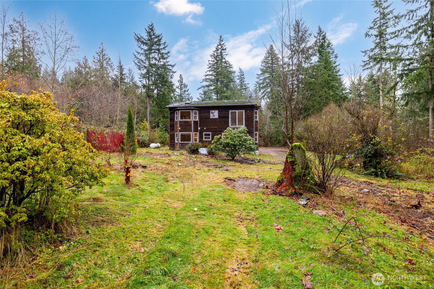 7308 Valley View Road Sedro-Woolley, WA 98284 - Photo 14 of 38 a view of a backyard with a sitting area and slide
