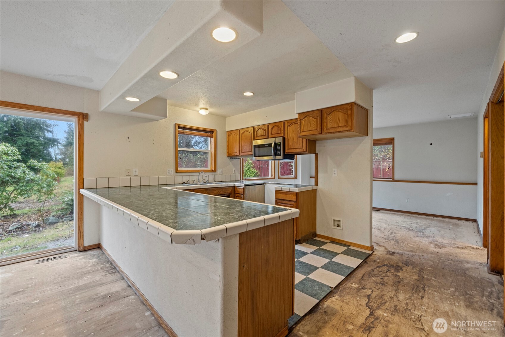 7308 Valley View Road Sedro-Woolley, WA 98284 - Photo 22 of 38 a kitchen with stainless steel appliances granite countertop a sink a refrigerator and a oven
