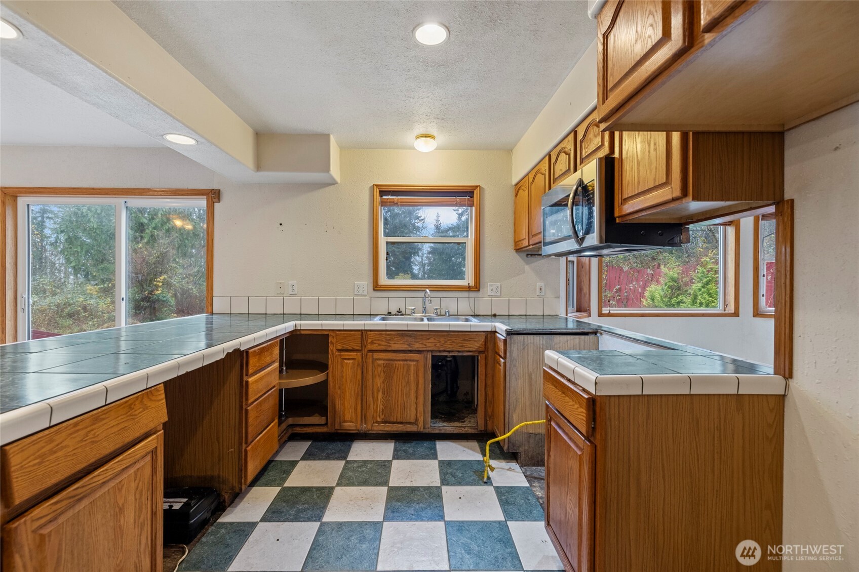 7308 Valley View Road Sedro-Woolley, WA 98284 - Photo 24 of 38 a large kitchen with a sink and a large window
