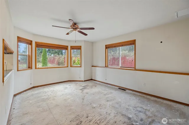 a view of a livingroom with a ceiling fan and window