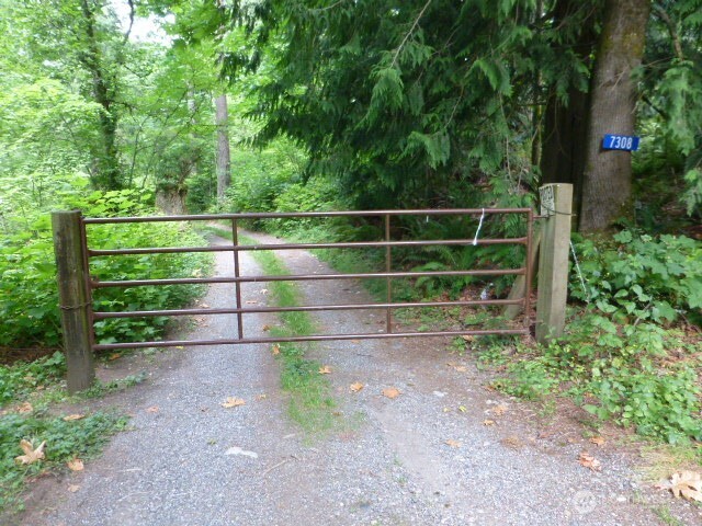 7308 Valley View Road Sedro-Woolley, WA 98284 - Photo 3 of 38 a view of a yard with wooden fence