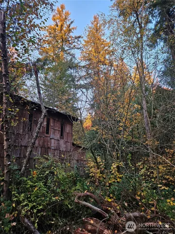 a brick building with large trees
