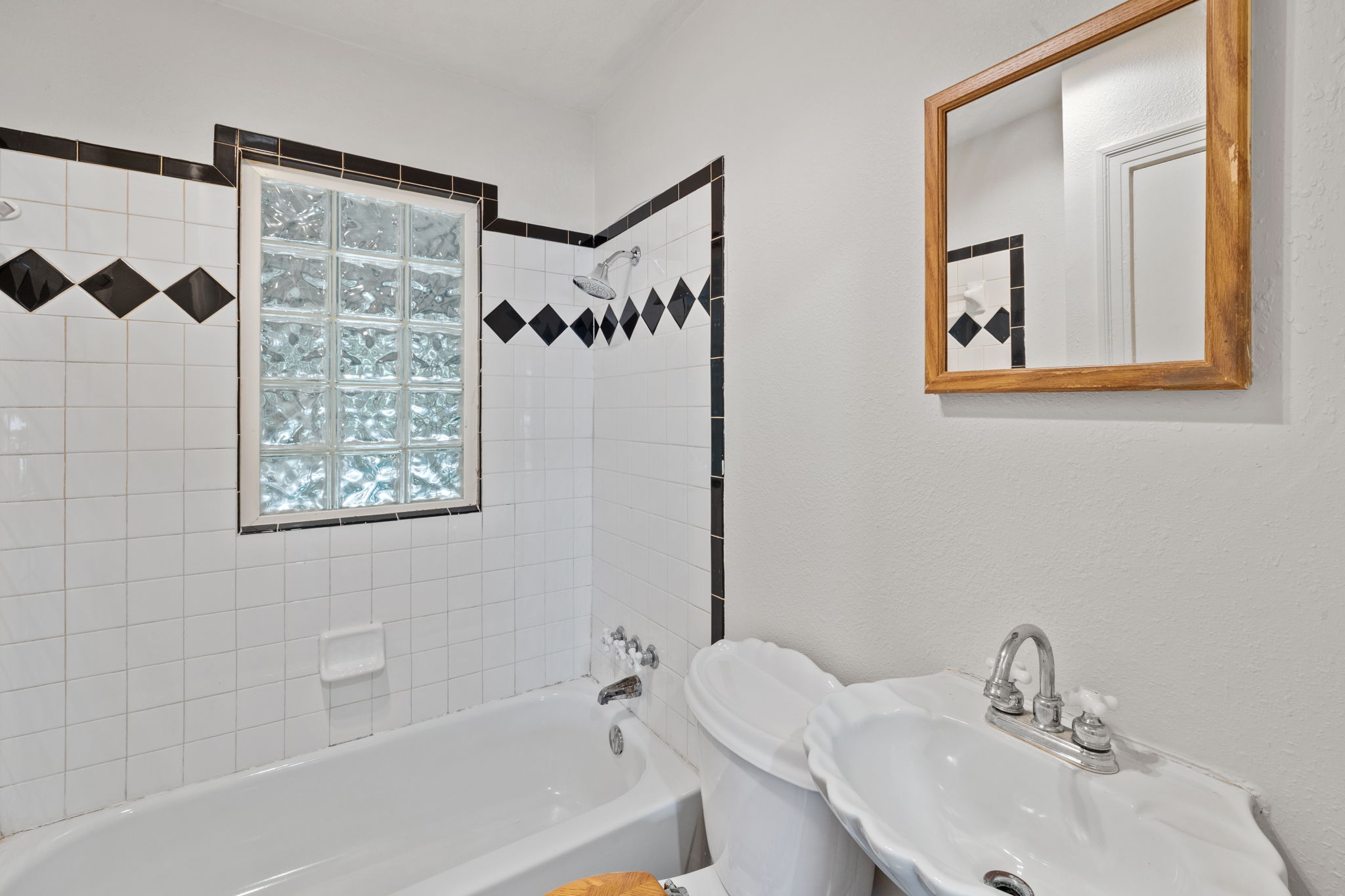 3704 Cherrywood Road Austin, TX 78722 - Photo 21 of 40 Timeless bathroom design with classic tilework and glass block window. window feature.