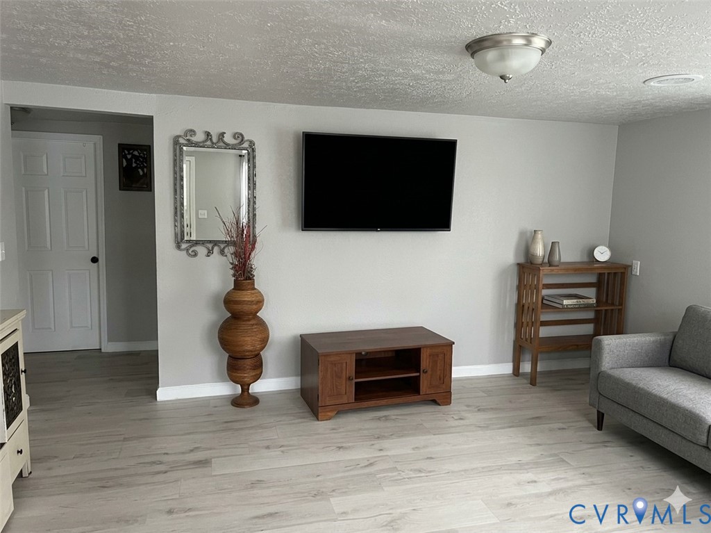 449 Colonial Trail West Dendron, VA 23839 - Photo 4 of 21 Living room with LVP flooring (digitally altered)