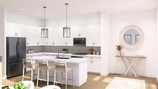 a kitchen with stainless steel appliances kitchen island granite countertop a sink a stove and refrigerator