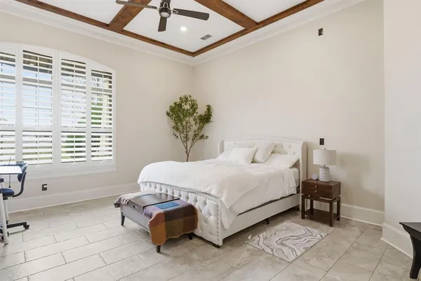 a spacious bedroom with a bed and a window