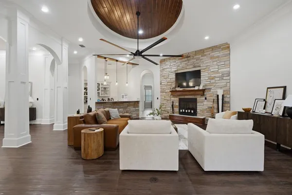 a living room with fireplace furniture and a wooden floor