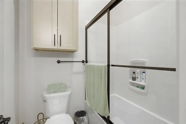 a bathroom with a bathtub a toilet and a shower