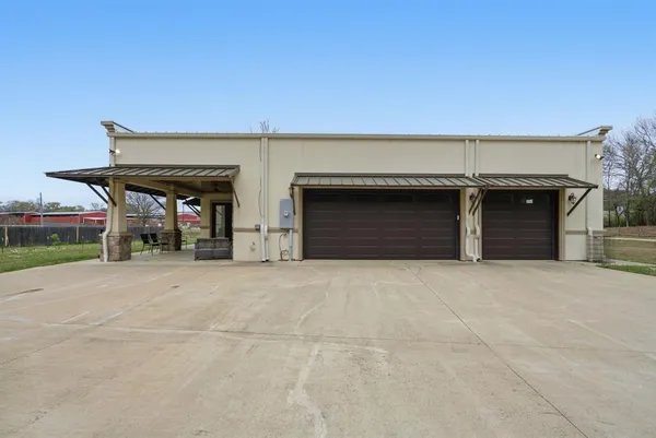 a front view of a building with retail shop and garage