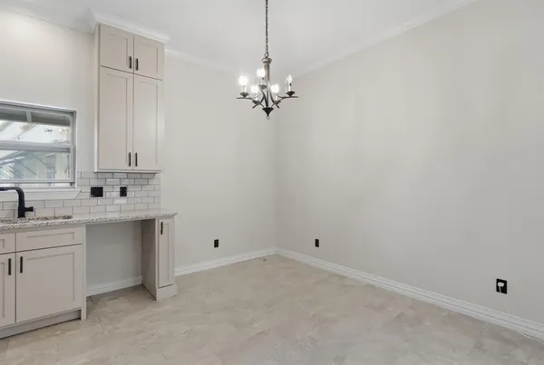 a view of cabinets and chandelier