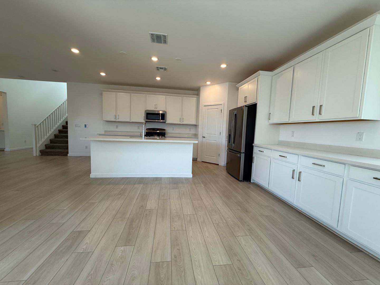 17760 West Cassia Way Goodyear, AZ 85338 - Photo 12 of 37 a view of kitchen with wooden floor and electronic appliances