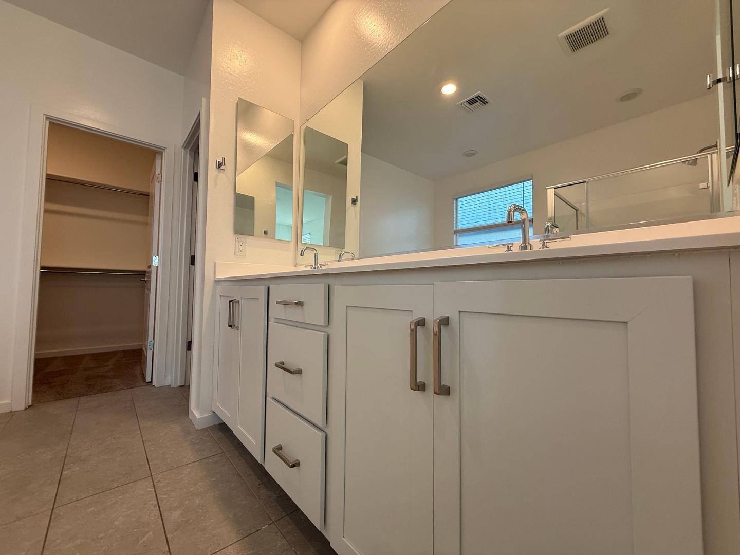 17760 West Cassia Way Goodyear, AZ 85338 - Photo 17 of 37 a bathroom with a double vanity sink and mirror