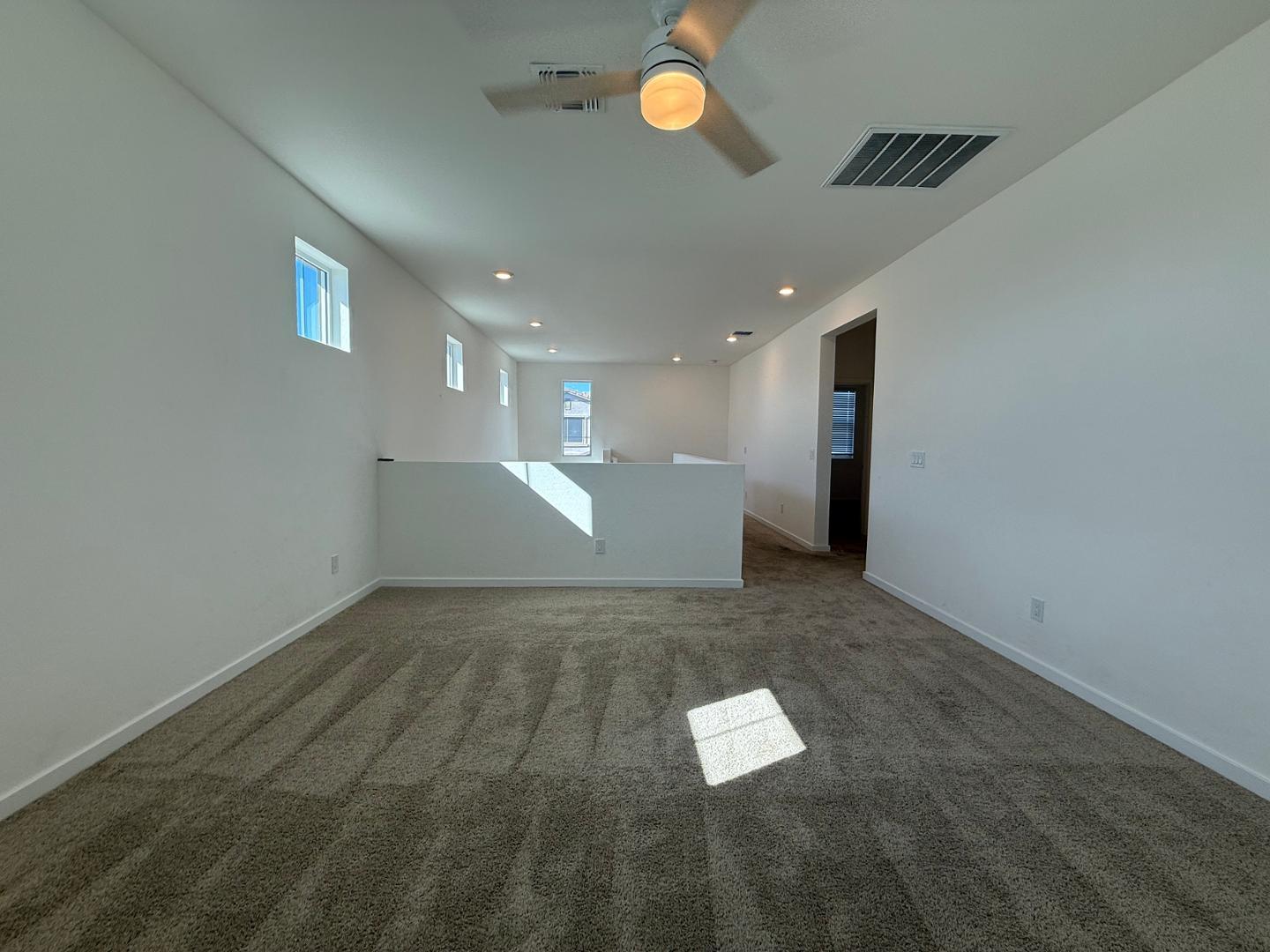 17760 West Cassia Way Goodyear, AZ 85338 - Photo 30 of 37 a view of empty room with wooden floor
