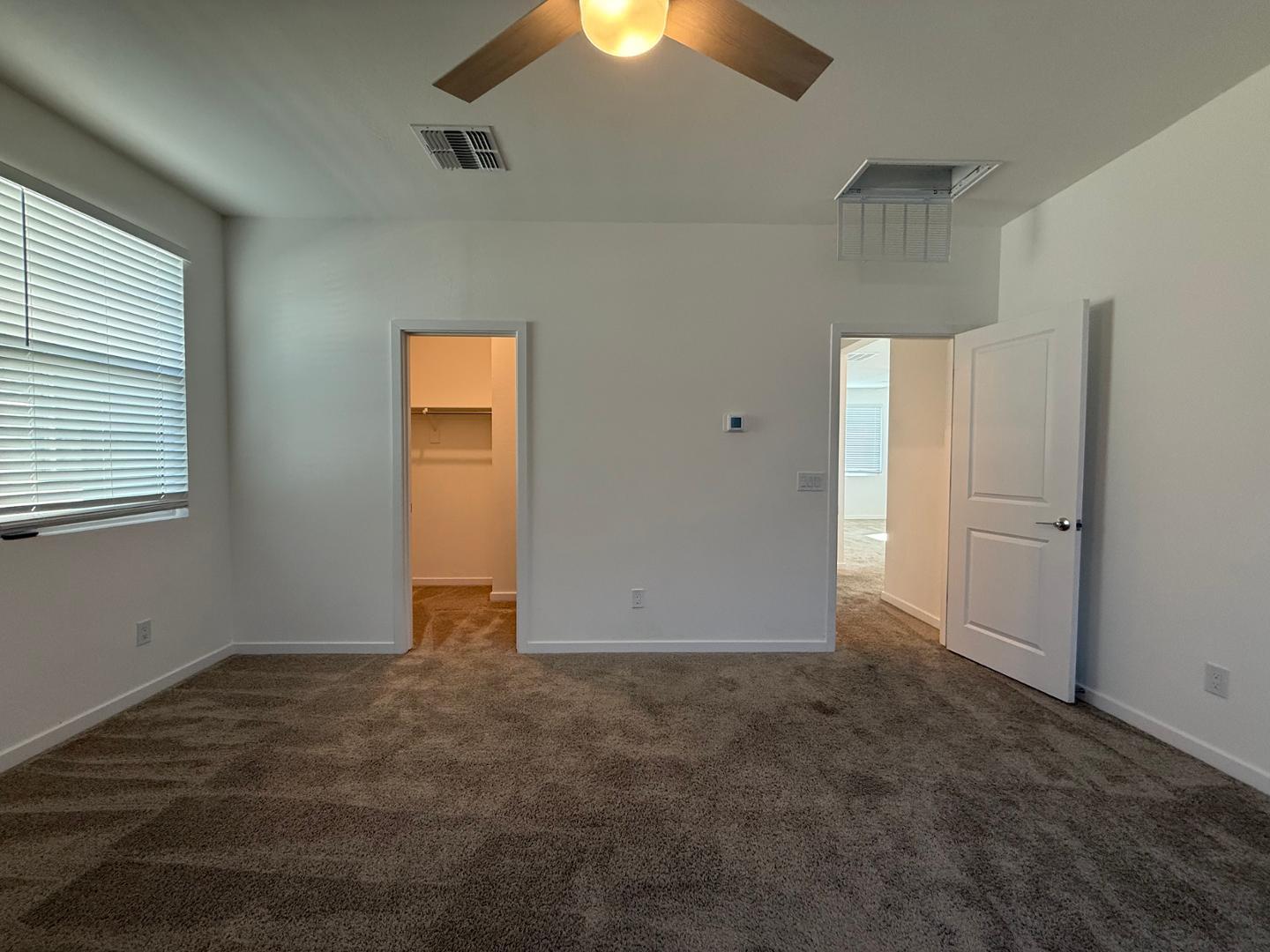 17760 West Cassia Way Goodyear, AZ 85338 - Photo 37 of 37 an empty room with yellow walls and windows