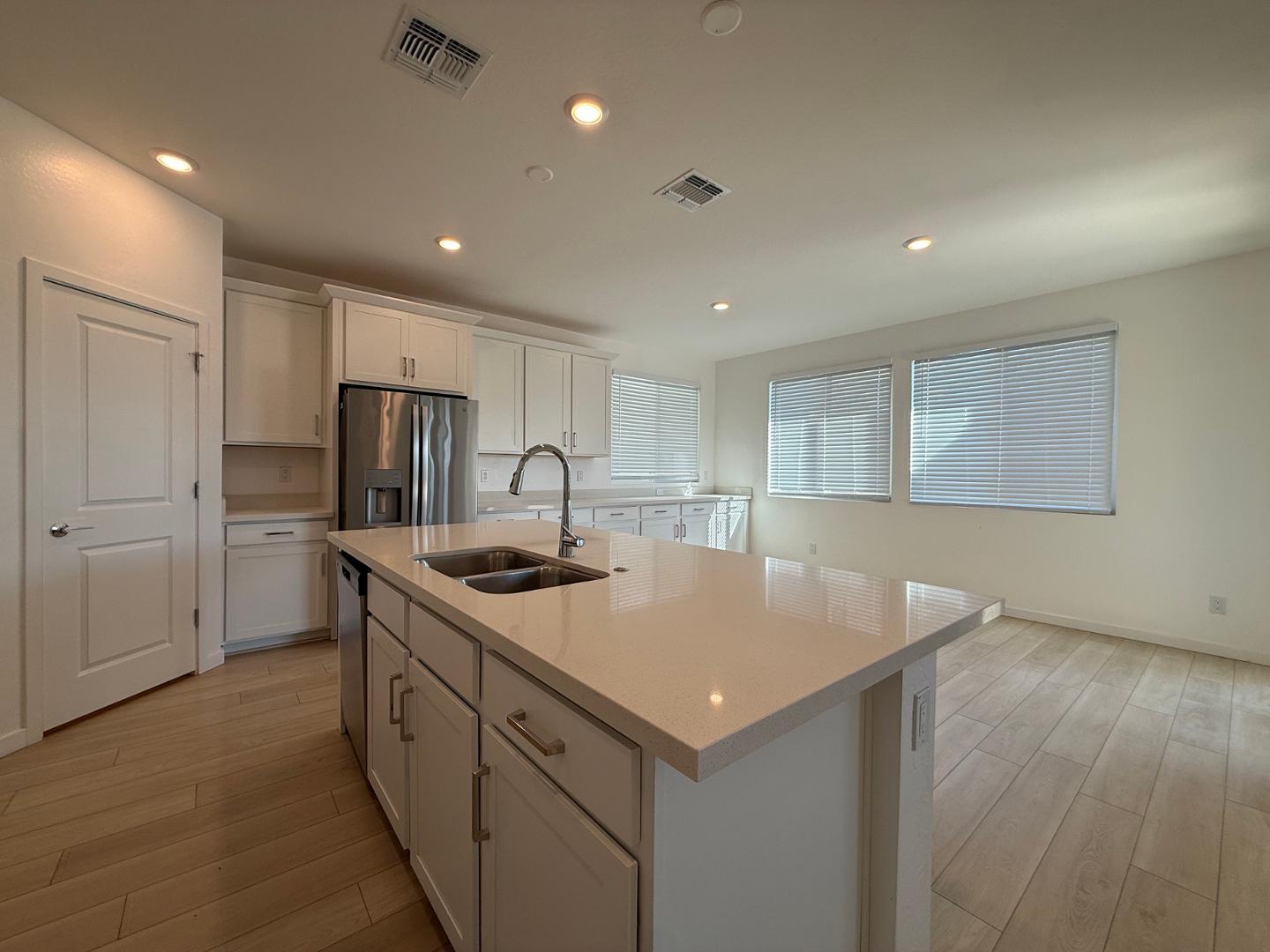 17760 West Cassia Way Goodyear, AZ 85338 - Photo 9 of 37 a kitchen with kitchen island a sink stove and refrigerator