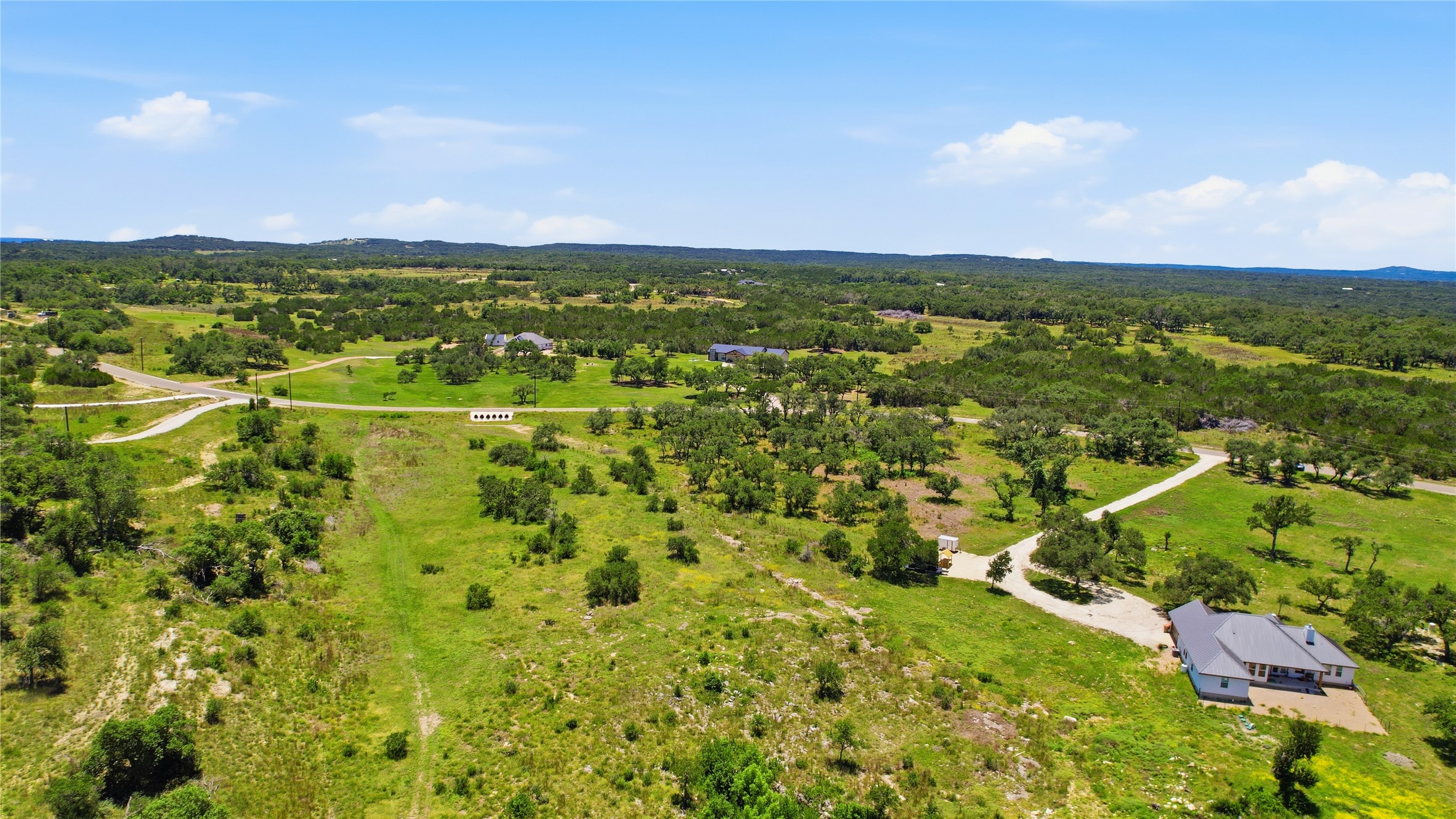 623 Whiskey Trail Blanco, TX 78606 - Photo 20 of 23 Rolling hills and mature trees create a private, serene backdrop for this secluded property