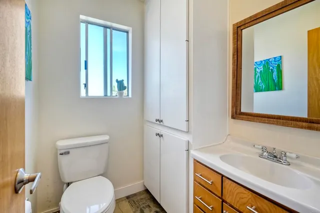 a bathroom with a toilet sink and mirror