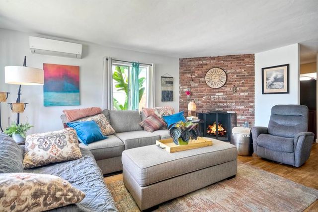 a living room with furniture fireplace and window