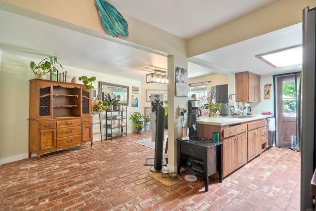 a large kitchen with stainless steel appliances granite countertop a refrigerator and a stove