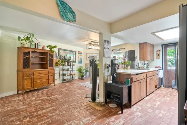 a large kitchen with stainless steel appliances granite countertop a refrigerator and a stove