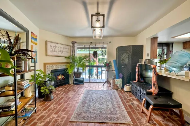 a living room with furniture a fireplace and a flat screen tv