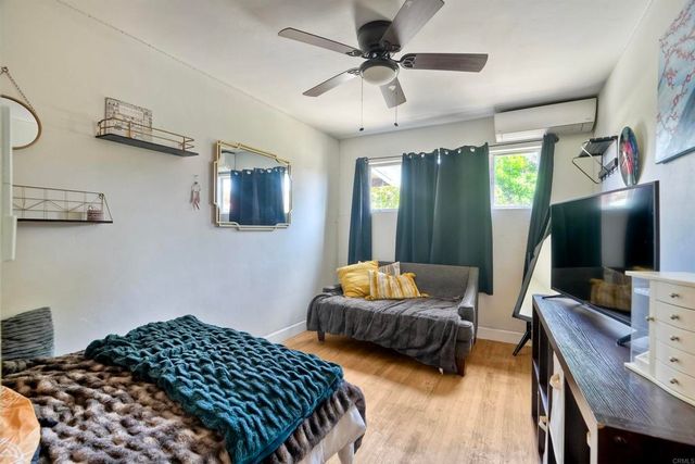 a bedroom with furniture and a flat screen tv