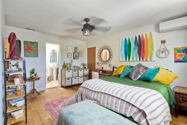 a bedroom with furniture and a large window