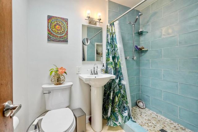 a bathroom with a sink mirror and toilet