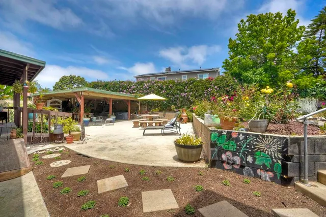 a view of a patio with couches chairs and potted plants