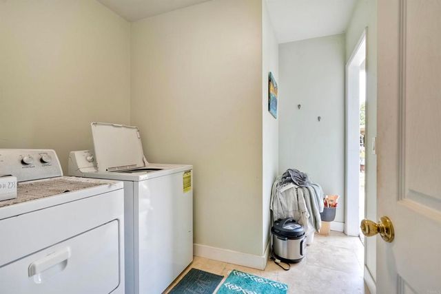 a view of storage and utility room with washer and dryer