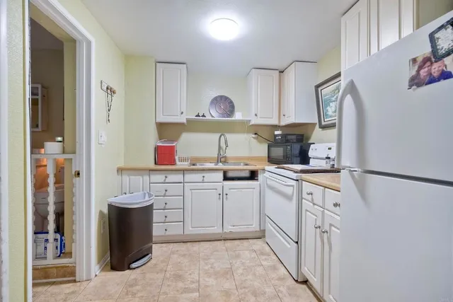a kitchen with stainless steel appliances granite countertop a refrigerator and a stove