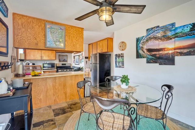 a dining room with furniture a chandelier and wooden floor