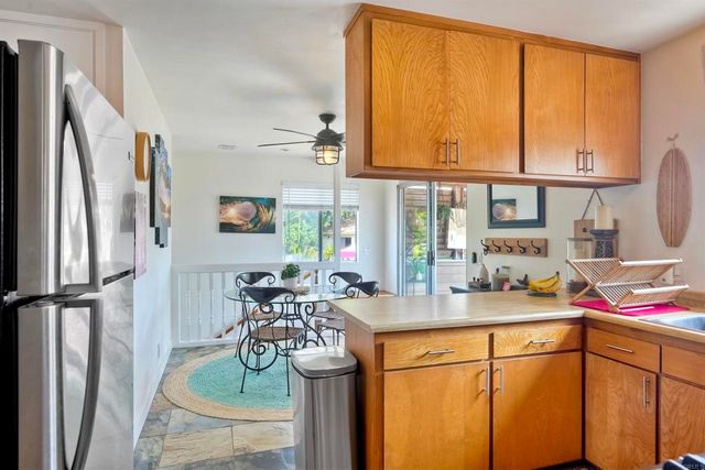 a kitchen with a sink appliances and cabinets