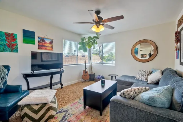 a living room with furniture a clock and a window