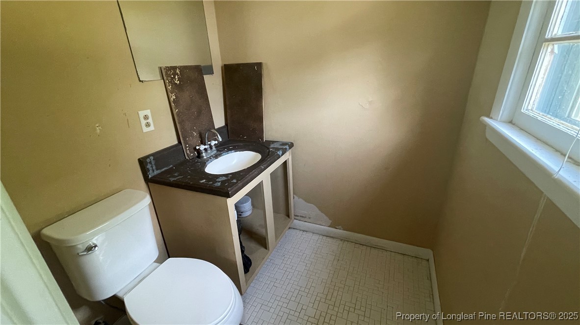 808 Bronco Road Fayetteville, NC 28303 - Photo 14 of 14 a bathroom with a toilet sink and mirror