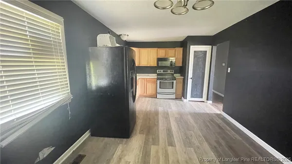 a kitchen with granite countertop a refrigerator and a sink