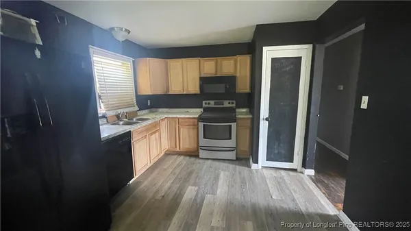 a kitchen with stainless steel appliances a stove top oven