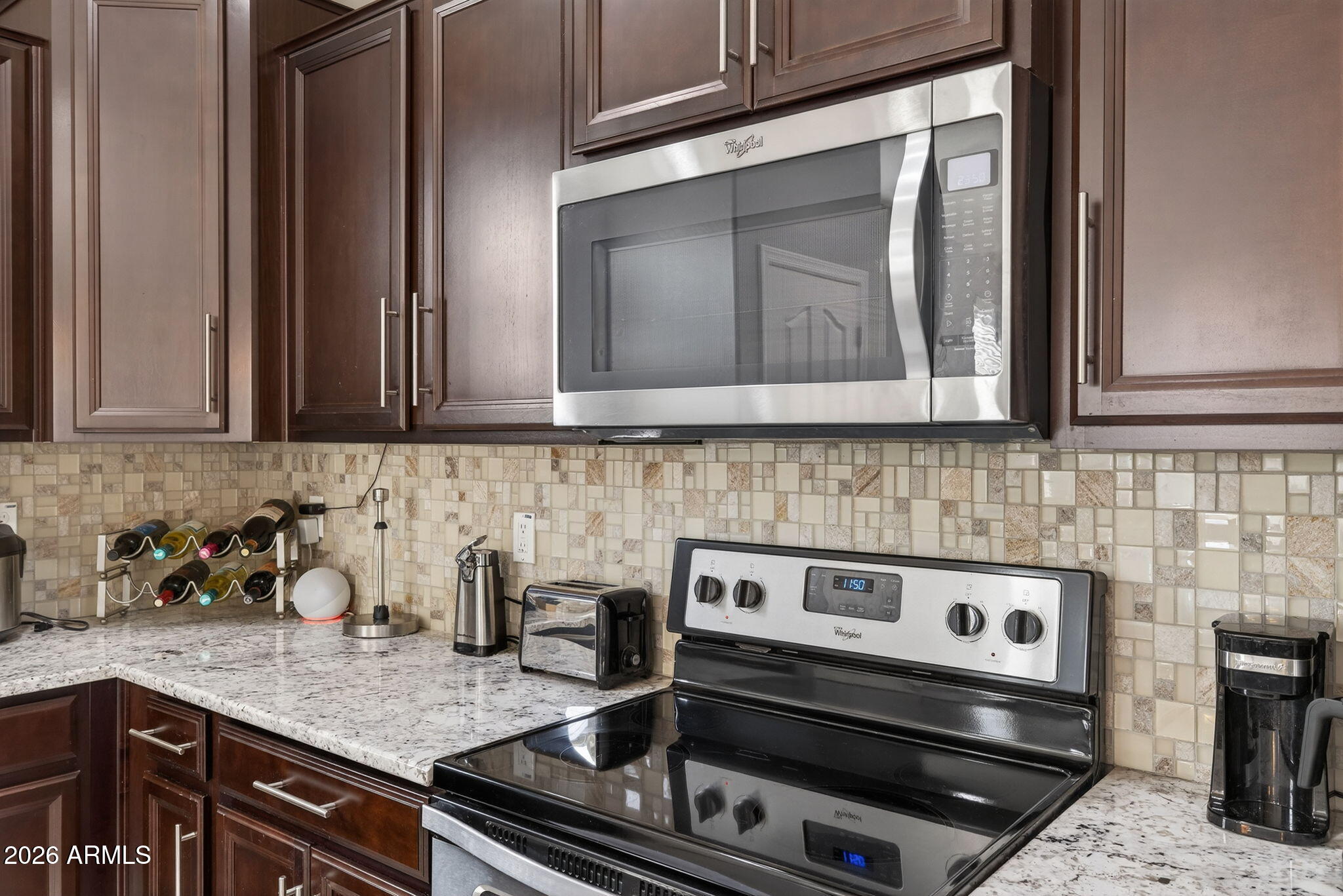 921 South Swallow Lane Gilbert, AZ 85296 - Photo 13 of 36 a kitchen with granite countertop a stove sink and cabinets