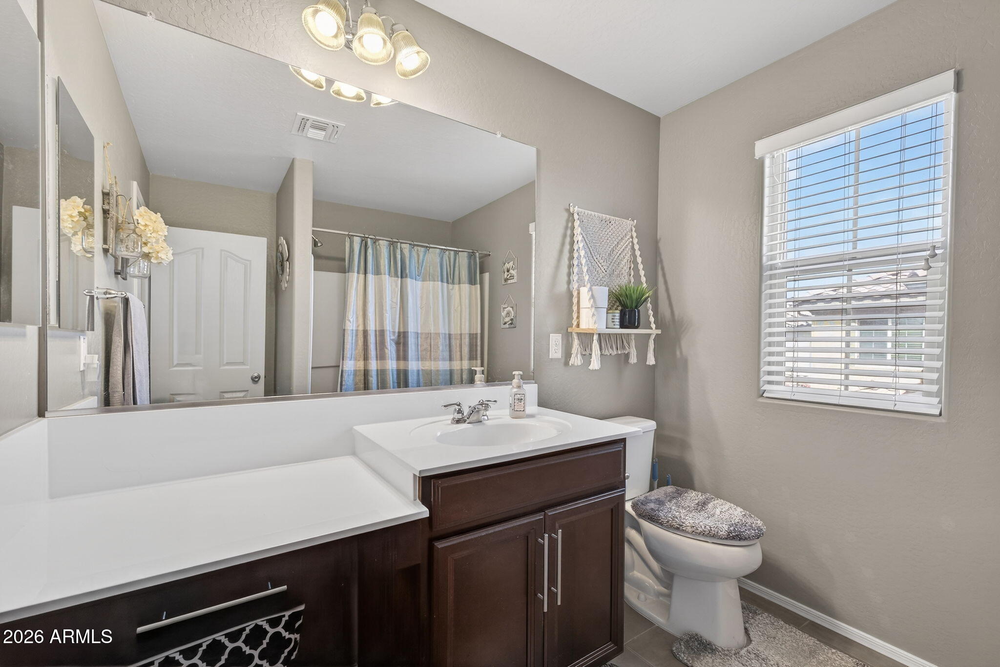 921 South Swallow Lane Gilbert, AZ 85296 - Photo 25 of 36 a bathroom with a sink a toilet and a mirror