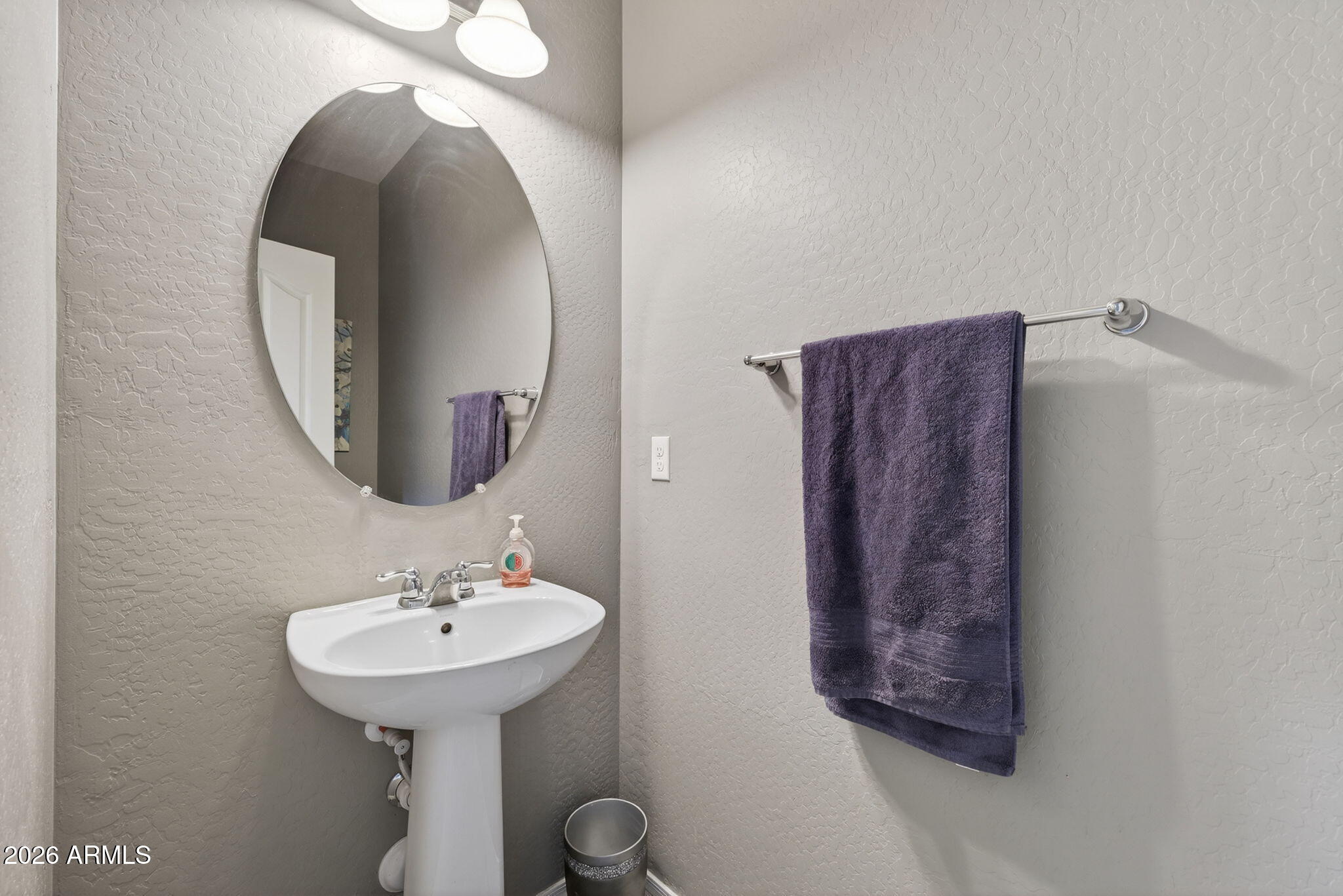 921 South Swallow Lane Gilbert, AZ 85296 - Photo 27 of 36 a bathroom with a sink and a mirror