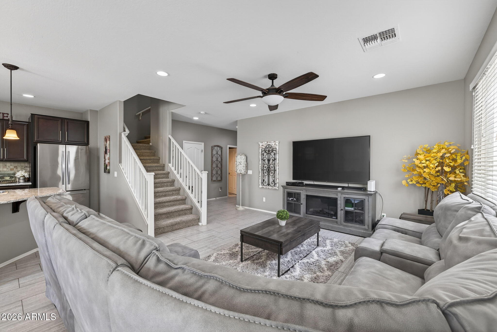921 South Swallow Lane Gilbert, AZ 85296 - Photo 6 of 36 a living room with furniture and a flat screen tv with wooden floor