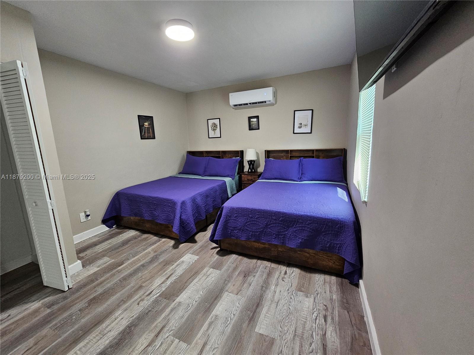 1265 Southwest 4th Street, Unit 4 Miami, FL 33130 - Photo 13 of 24 a bedroom with two beds and a lamp