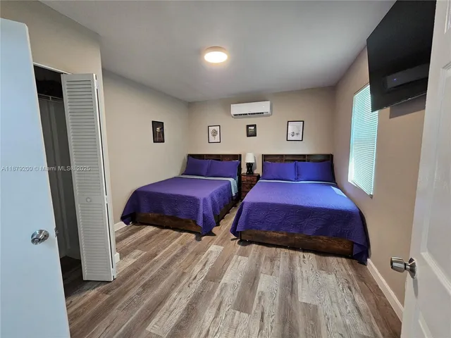 a bedroom with two beds and a lamp