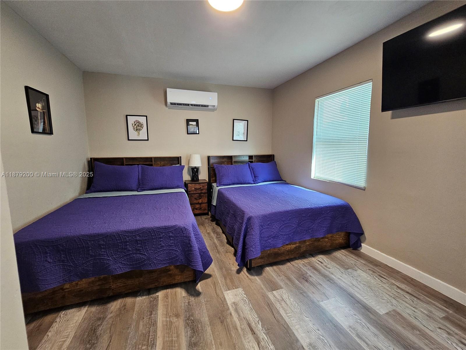 1265 Southwest 4th Street, Unit 4 Miami, FL 33130 - Photo 16 of 24 a bedroom with a bed and a flat screen tv