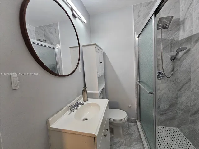 a bathroom with a sink toilet and a mirror