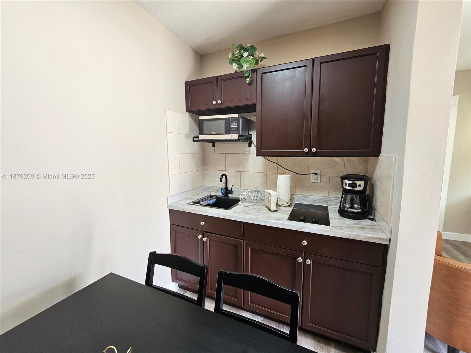 1265 Southwest 4th Street, Unit 4 Miami, FL 33130 - Photo 9 of 24 a kitchen with a sink cabinets and appliances