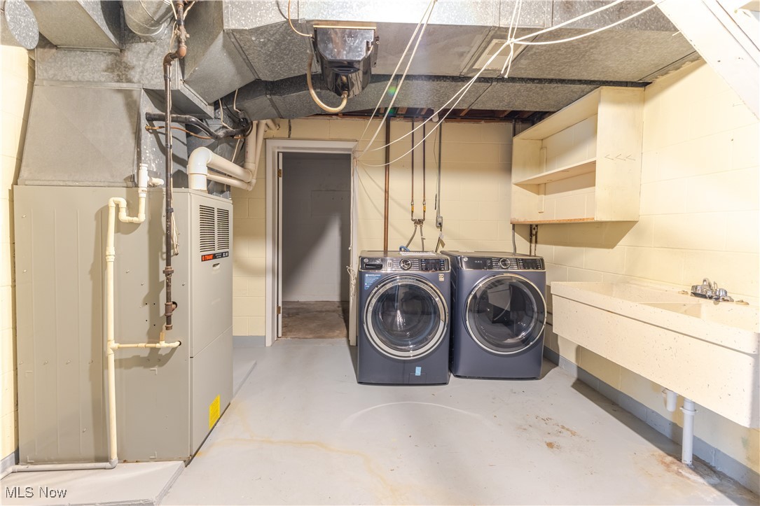 155 Forest Road Weirton, WV 26062 - Photo 23 of 28 Unfinished below grade area featuring heating unit and separate washer and dryer