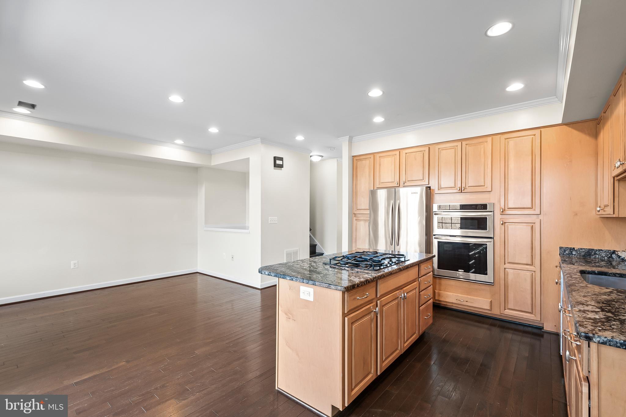 7872 Azalea Cove Terrace Alexandria, VA 22315 - Photo 11 of 30 a kitchen with stainless steel appliances kitchen island granite countertop a stove a sink and a refrigerator